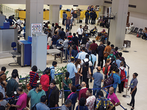 Passengers waiting in the queue at the security checkpoint in the departure terminal of Bandaranaike International Airport in Colombo, Sri Lanka.